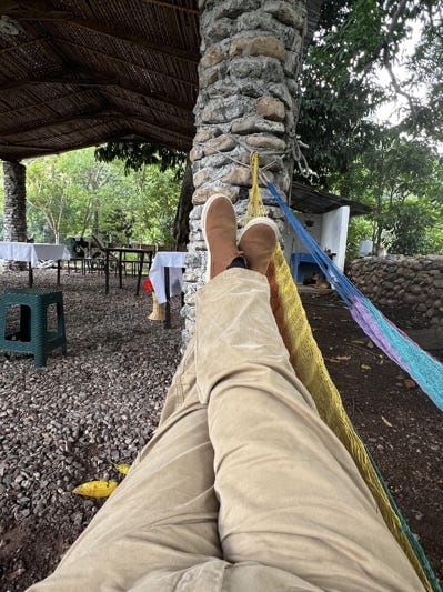 A person's legs and feet on a hammock
AI-generated content may be incorrect.